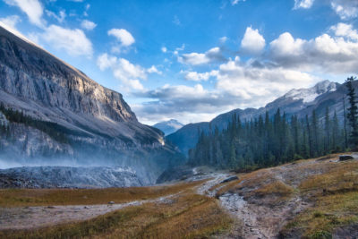 Mist drop off at Emperor Falls surrounded by mountain ranges on the Berg Lake Trail in Mount Robson Provincial Park